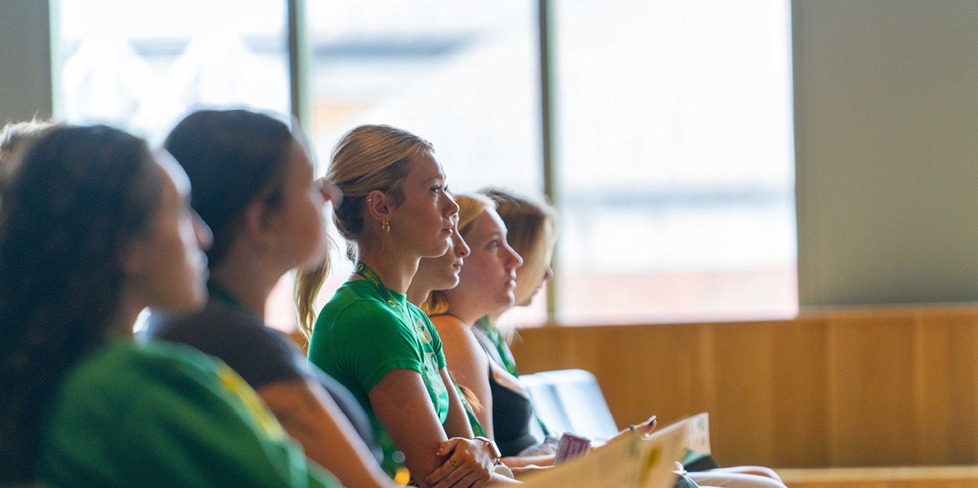 Students in a classroom paying close attention to something out of view