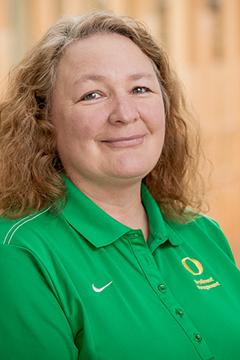 Profile photo of Kyna Burgett wearing a UO-branded green polo shirt.