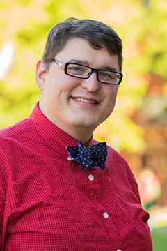 Profile photo of Tyler Pundt wearing a red button down shirt and a dark blue bow tie